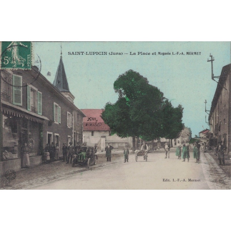 SAINT-LUPICIN - LA PLACE ET MAGASIN L.F.A. MERMET - CARTE DATEE DE 1907.