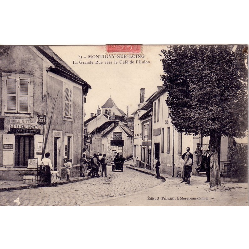 MONTIGNY SUR LOING - LA GRANDE RUE VERS LE CAFE DE L'UNION - MAGASIN PIECES AUTO-MOTO - ANIMATION - CARTE DATEE DE 1905.